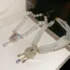 Wholesale Flowers Pendant Necklace For Women With Alloy Pendant Material Featuring Imitation Pearl And Rhinestones In White