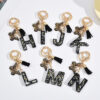 Wholesale resin black English letter car key chain pendant butterfly pendant tassel key chain decoration