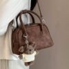 oly-f6d4ec1641ab9e694759ad5f00be077c Wholesale Korean niche brown bowling ball handbag for women, autumn/winter style, high-end retro crossbody bag.