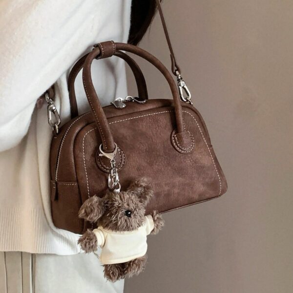 oly-f6d4ec1641ab9e694759ad5f00be077c Wholesale Korean niche brown bowling ball handbag for women, autumn/winter style, high-end retro crossbody bag.