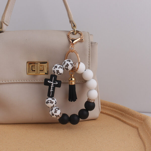 oly-0b17098501d663e4166878bf000b408a Wholesale Silicone Cross Print Bead Bracelet Keychain with PU Tassel Fashion Accessory for Resale