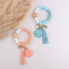 oly-0f3d02de894bc4f368dbd5785b6b4d40 Wholesale Silicone Keychain Retro Face Wooden Plaque Tassel Wristlet Party Gift for Junior