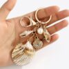 oly-2dcfc0cbf3edb032ea30d0bd6962b994 Wholesale Resin Gold Plated Shell Keychain Pendant for Bag Car Decoration Boutique Resale