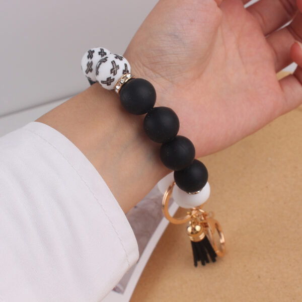 oly-35317a0f9039fe0472f5c337abab697b Wholesale Silicone Cross Print Bead Bracelet Keychain with PU Tassel Fashion Accessory for Resale