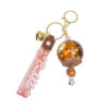 oly-396074e74b75f2d03805be5d96413c24 Wholesale Oil filled Wind Chime Acrylic Keychain Bag Charm Gift for Boutique Resale