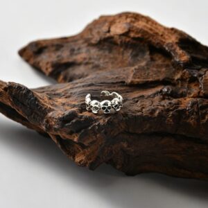 One of eight skull ear clips - bright silver