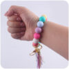 oly-3b57adc42aa194d746cd29c5fe0d6346 Wholesale Western Style Bull Head Keychain Bracelet Silicone Bead with Tassel Fashion Accessory