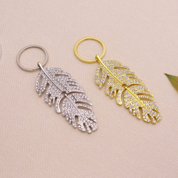 oly-3d5aae6471172c569439a5957d01d23a Wholesale Light Luxury Feather Rhinestone Long Pendant Keychain Metal Car Key Accessory