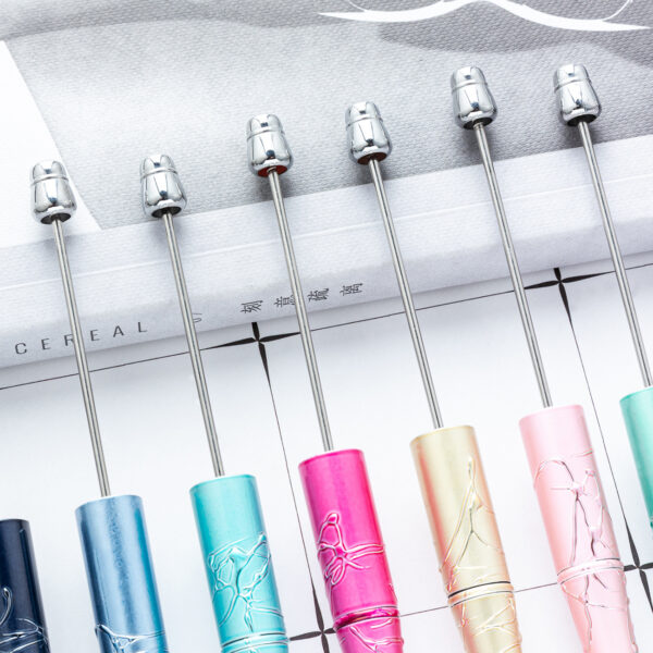 oly-401ff61a11294e5eec1075cc59f99b0e Wholesale Plastic Beaded Pens with Embossed UV Design Multicolor Rotating for Office Gift Resale