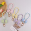 oly-51ddd78d3bd35ef1b14fd823acf129ee Wholesale Silicone Dopamine Bow Phone Strap Heart Keychain Fashion Accessory Yellow