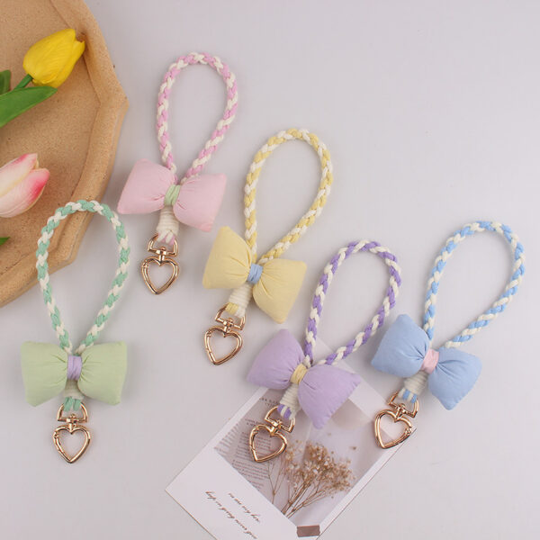 oly-51ddd78d3bd35ef1b14fd823acf129ee Wholesale Silicone Dopamine Bow Phone Strap Heart Keychain Fashion Accessory Yellow