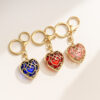 oly-5aff810c702b932eea23acc55996b040 Wholesale Fashion Metal Heart Keychain Pendant, Red Hollow Design, European Style Bag and Key Accessory OLY Exclusive