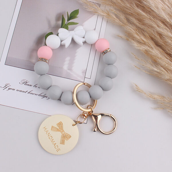 oly-5ed0d6371ad24b53ae99305a201c1a17 Wholesale Trendy Silicone Bow Keychain Bracelet Mother's Day Gift Car Key Accessory