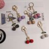 oly-640cdf7c9a3f9388288f8645955deb15 Wholesale Rustic Style White Ceramic Cherry Keychain with Rhinestones Car Key Accessory