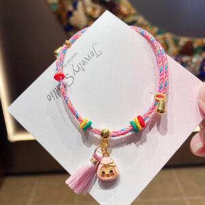 Pink rice dumplings with colorful ropes and tassels in a bag