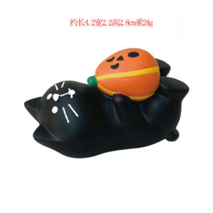 Black cat holding pumpkin