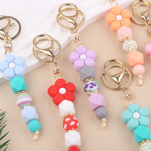 oly-790795bc9a5a75389dca197eac8ec546 Wholesale Pink Silicone Bead Bracelet Cartoon Flower Keychain DIY Pendant Fashion Accessory Gift