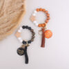 oly-79a2e11213ce4e7bd3845631bdd6825f Wholesale Silicone Keychain Retro Face Wooden Plaque Tassel Wristlet Party Gift for Junior