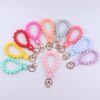 oly-7bcccdfbb81992431d784b807fd76c85 Wholesale Pink Silicone Cartoon Flower Beaded Wristband Keychain Boutique Jewelry Accessory
