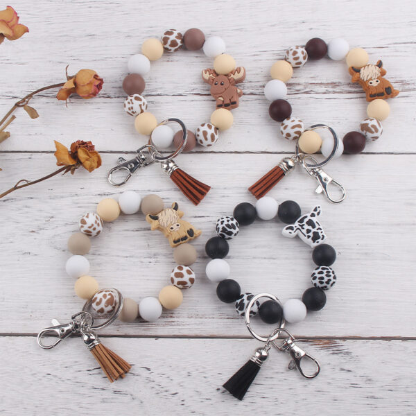 oly-84b07e47c68aef4ce1b33aeb798ea375 Wholesale Silicone Cartoon Cow Keychain with PU Leather Tassel Fashion Accessory Bag Charm for Gift Boutique Resale