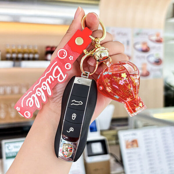 oly-9e53a097339f45479d850611b7448f67 Wholesale Decorative Pink Hot Air Balloon Acrylic Keychain with Oil Filled Quicksand Bag Charm Gift