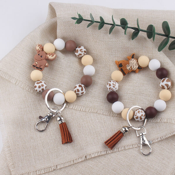oly-a73ed3886feb9076c69aa6d24ab96b31 Wholesale Silicone Cartoon Cow Keychain with PU Leather Tassel Fashion Accessory Bag Charm for Gift Boutique Resale