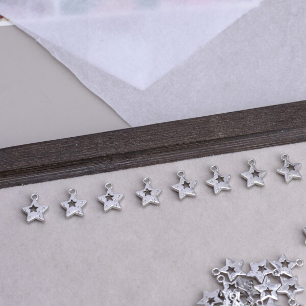 oly-ae47f4b726c94ce899193b60f7c84f54 Wholesale Hollow Five Pointed Star White Tone Alloy Charm DIY Jewelry Bag Charm Fashion Accessory