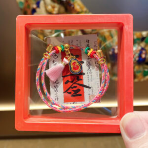 Gourd with colorful rope tassels, red box with cardboard