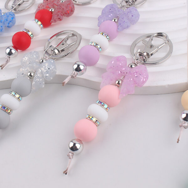 oly-d24480a9476f2321b6d77377efa12544 Wholesale Silicone Bow Beaded Bag Charm Keychain Fashion Accessory Gift for Party