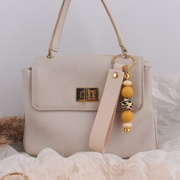oly-d9dd83bb4e52fc82cd59d48f75e31c61 Wholesale Stylish Silicone Khaki Keychain Pendant - Boutique Resale Bag Charm Gift