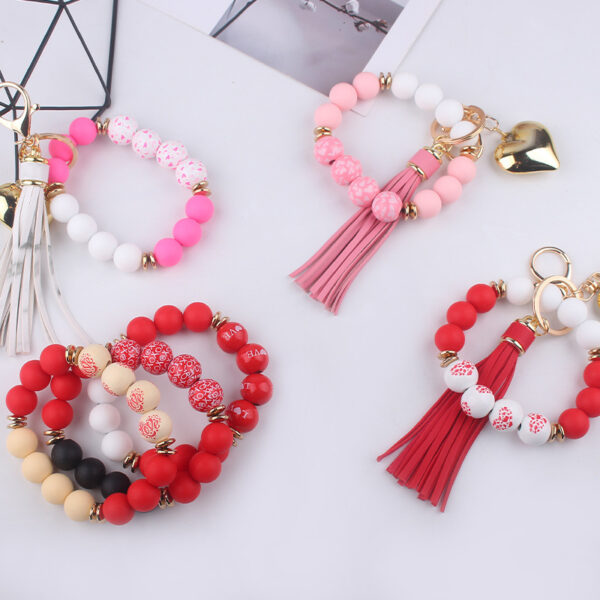 oly-dcd2ccf6601b38c381f7fd5c6d3fbd8c Wholesale Silicone Heart Bead Bracelet Keychain with Leather Tassel European Style Gift