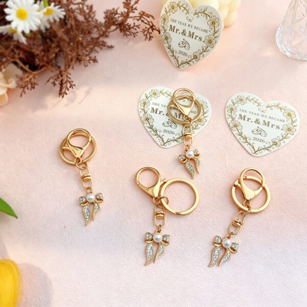 oly-dd42c579d2a50ee8dbb1fc6134ea180a Wholesale Gold Rhinestone Bow Pearl Keychain Wedding Favor Decorative Accessory