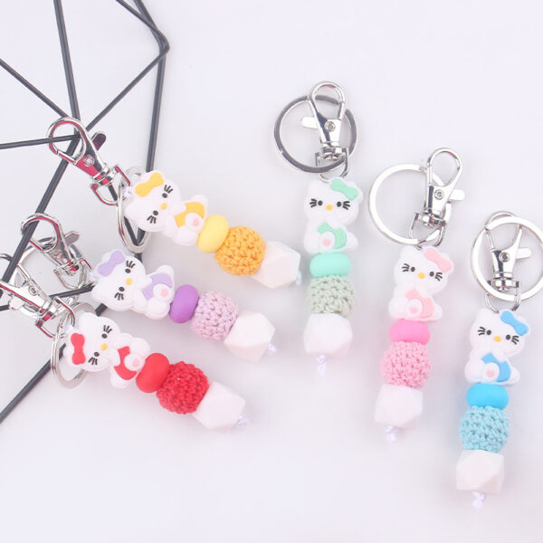 oly-e954279902411b1d39b3de677e8e1da7 Wholesale Silicone Cartoon Cat Bead Bracelet Keychain Trendy Bag Charm for Party Favors