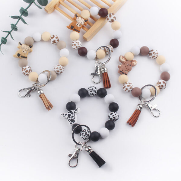 oly-eb3768992d8f916b7872b9c9d85cda6b Wholesale Silicone Cartoon Cow Keychain with PU Leather Tassel Fashion Accessory Bag Charm for Gift Boutique Resale