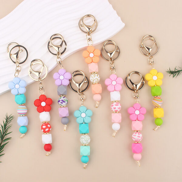 oly-ed2f070ab044cefa10d0c05f7e07baaa Wholesale Pink Silicone Bead Bracelet Cartoon Flower Keychain DIY Pendant Fashion Accessory Gift