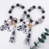 oly-f86be54d339a25fedda1f9cbf4712a4d Wholesale Silicone Cartoon Cow Head Keychain with Bead Bracelet and Tassel Korean Style Decorative Accessory