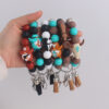 oly-fc973e3d9248a0412c038cb35f962c3e Wholesale Western Cowboy Silicone Beaded Bracelet Keychain Trendy Tassel Bag Charm for Party Gifts