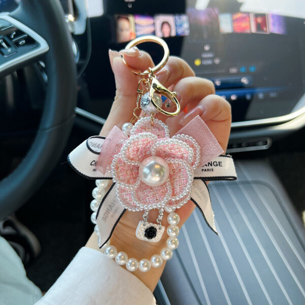 oly-94d261f8146cfefa2c060c3bdc5e6850 Wholesale Zinc Alloy Camellia Bow Bag Charm Keychain Black Pearl Chain Car Key Accessory Chic Boutique Resale