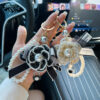 oly-bdf659b41469f60d5b0b4a243d6e524e Wholesale Zinc Alloy Camellia Bow Bag Charm Keychain Black Pearl Chain Car Key Accessory Chic Boutique Resale